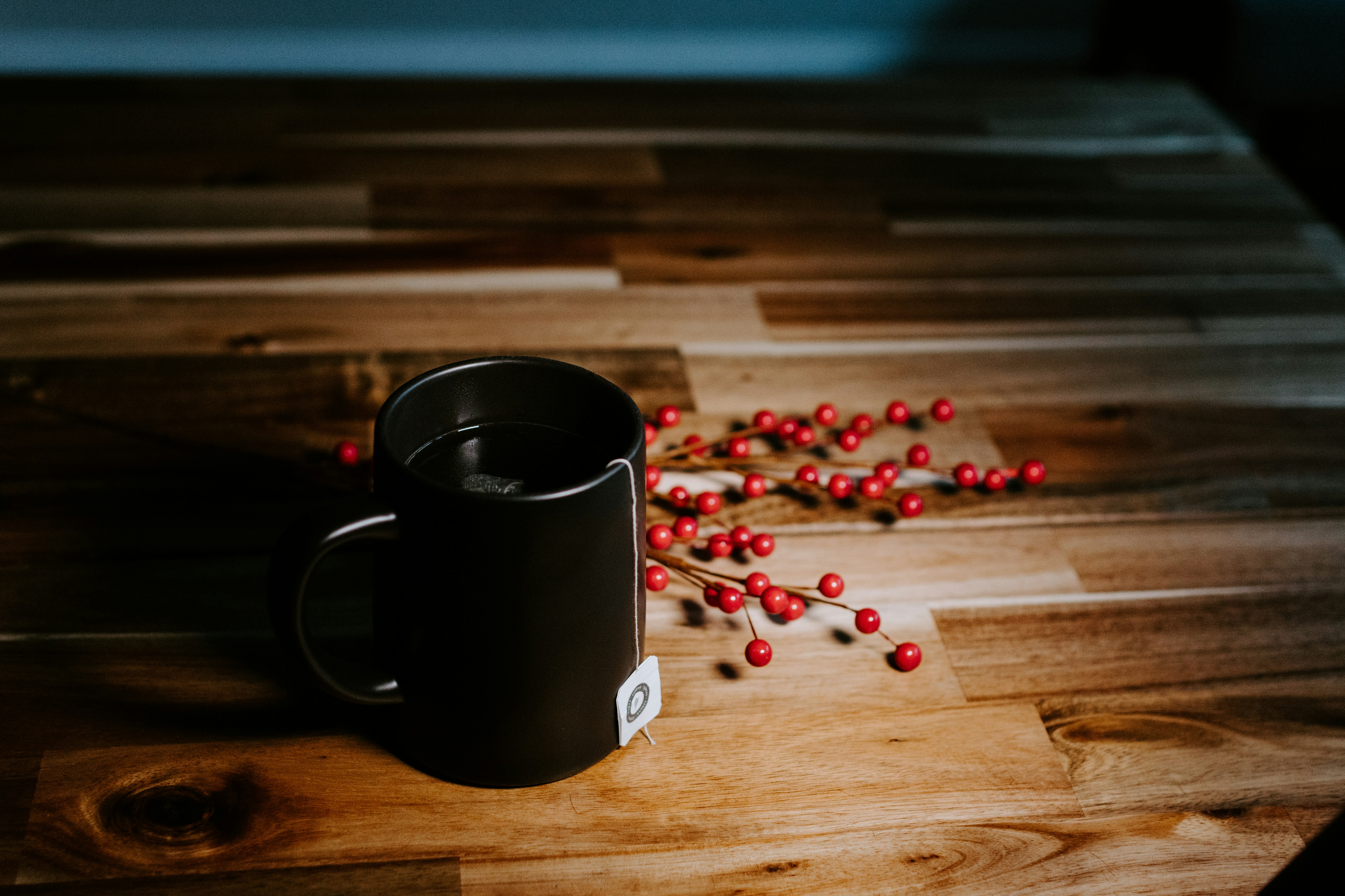 black ceramic mug on brown wooden table